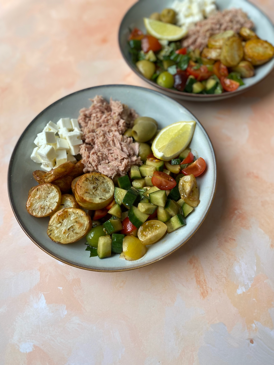 Mediterranean Style Salad with Herby New Potatoes - A fresh and filling Mediterranean salad with crispy new potatoes, hearty tuna, juicy cherry tomatoes and a tangy dressing. Ideal for lunches or summer dinners.